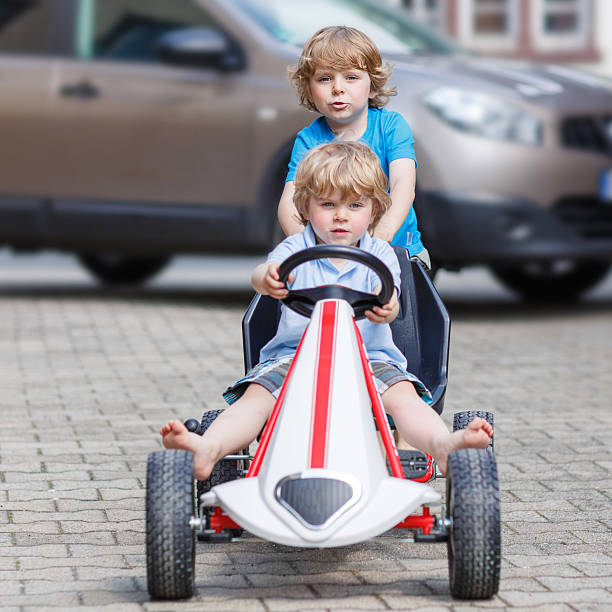 istock Two happy boy friends having fun with toy car 477096878