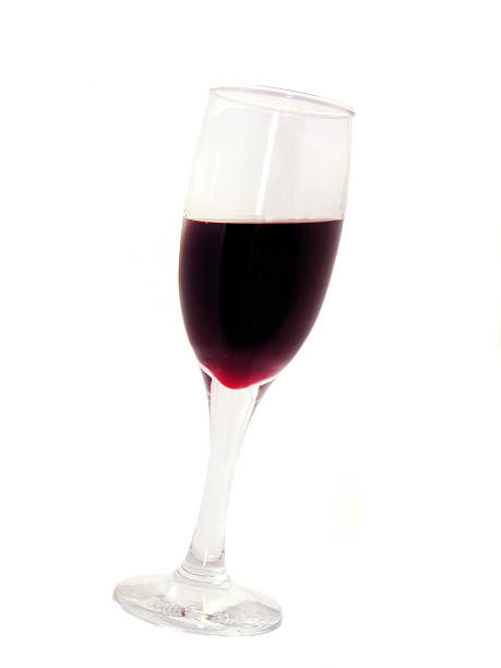 istock Red wine in a glass isolated on white background 477097997