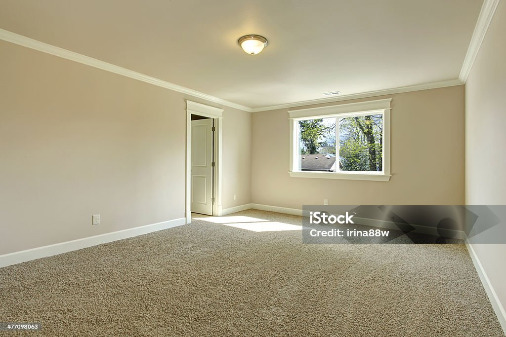 Bright empty bedroom Bright empty room with one window, beige carpet floor and ivory walls Carpet - Decor Stock Photo