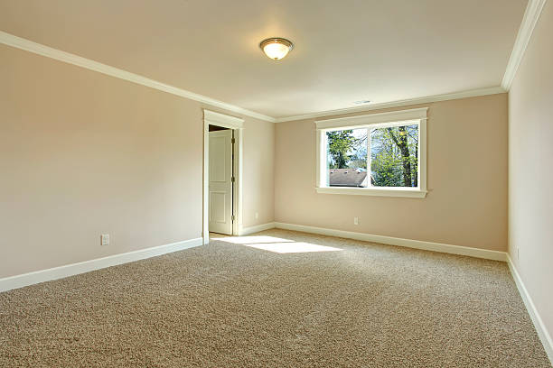 Bright empty bedroom Bright empty room with one window, beige carpet floor and ivory walls beige bedroom stock pictures, royalty-free photos & images