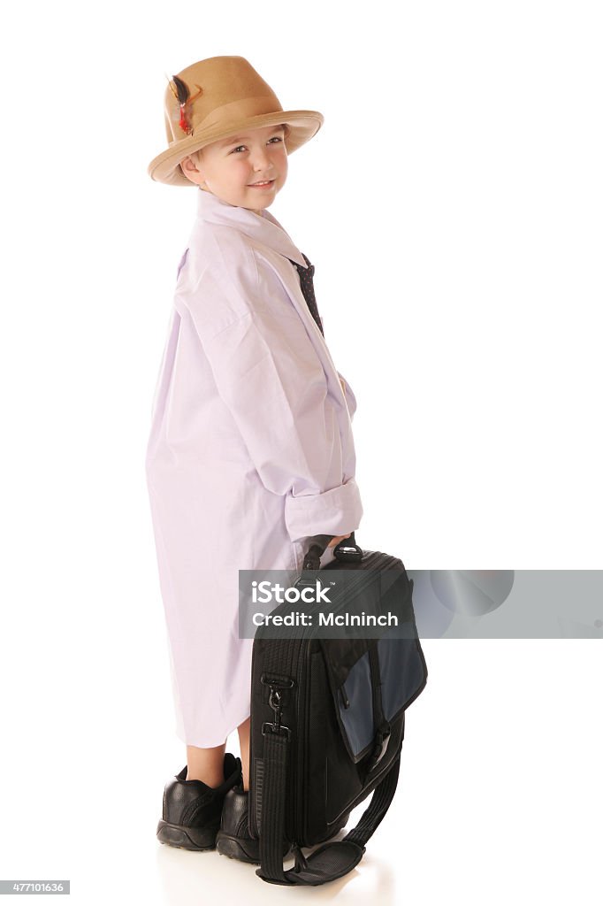 Looking Like Grandpa A handsome kindergarner looking back as he carries a computer case while dressed in grandpa's clothes.  Isolated on white. Oversized Object Stock Photo