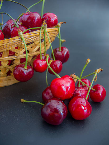 istock fresh red cherries on a basket on black background 477104804