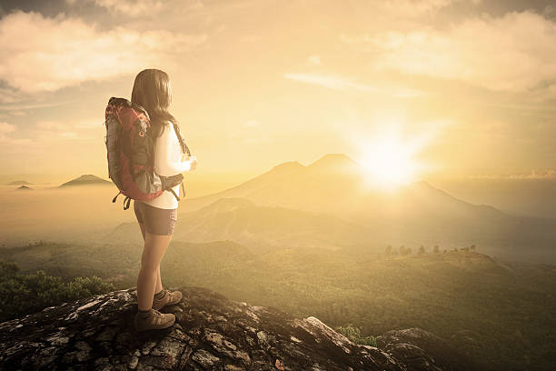 istock Woman enjoying valley view from mountainside 477105058