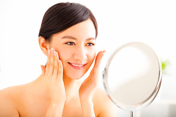 istock Happy young woman  looking on mirror 477105292
