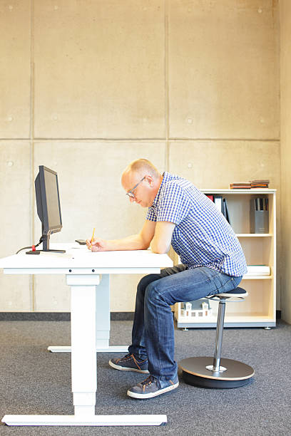 istock middle age man in bad sitting position on seat 477105910