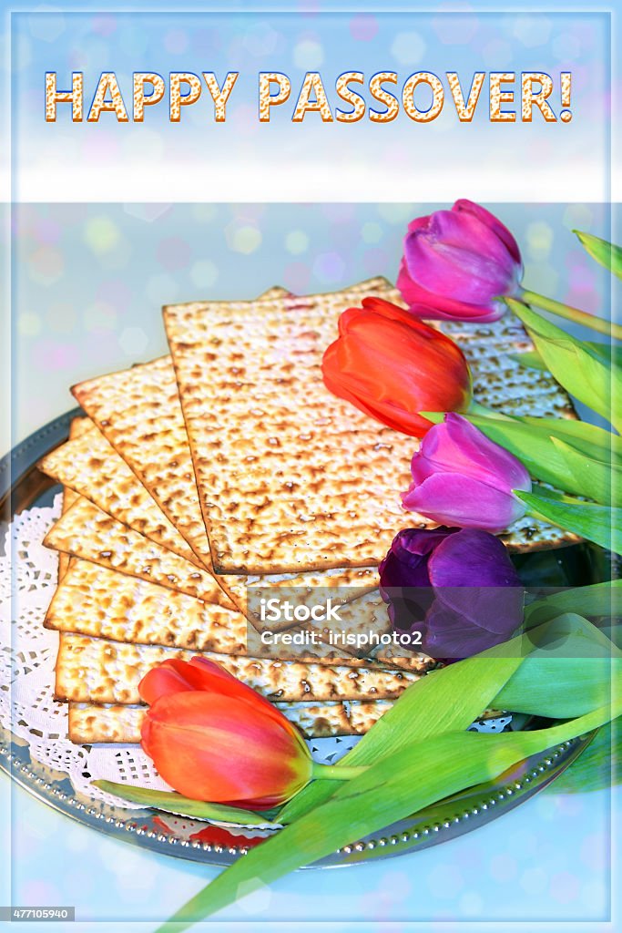 Happy Passover jewish holiday of Passover and its attributes, with matzo and spring tulips with the inscription Happy Passover Seder Stock Photo