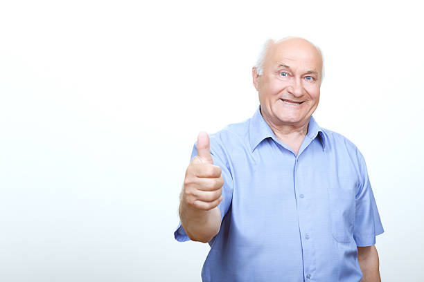 istock Old man thumbing up isolated on white background 477111092
