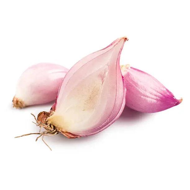 Studio photograph and in macro mode of a fresh and slightly peeled shallot, isolated on a white background, with a natural shadow. The focus is made on the main bulb in the center and the file can be used separately as a design element.