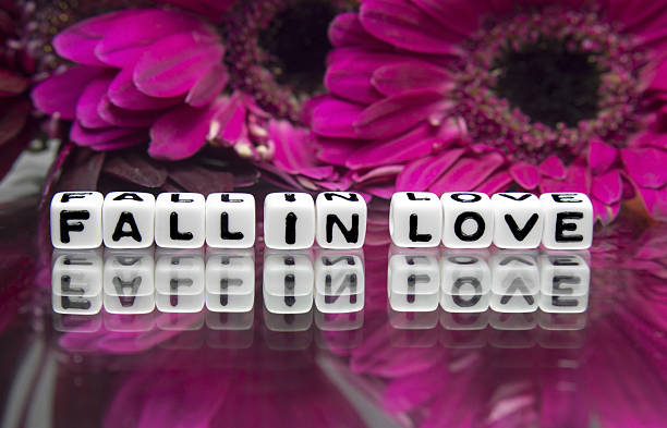 istock Fall in love message with pink big flowers 477113339