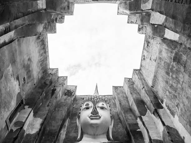 Big old Buddha sit in the ruin temple  without roof  in Thailand black and white color