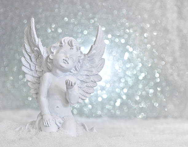 istock little white guardian angel in snow 477115869