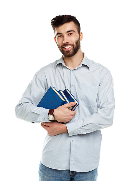 istock Young bearded smiling man with books in hands on white 477120366