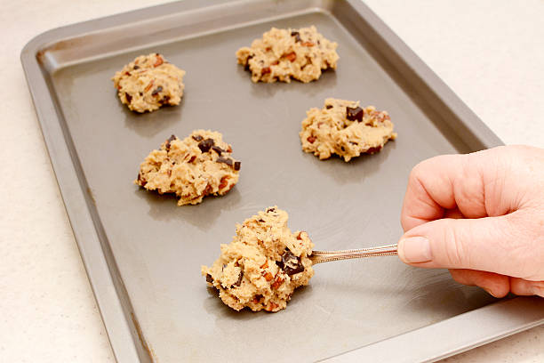 istock Spooning chocolate chip and pecan cookie dough 477121771