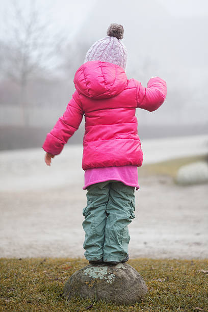 istock Balancing girl from behind 477122309