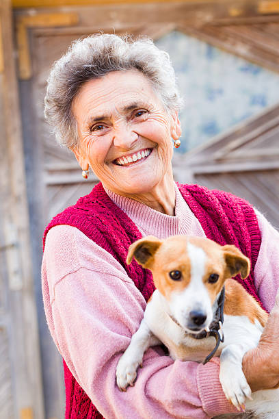 istock Laughing Woman with Puppy 477122347