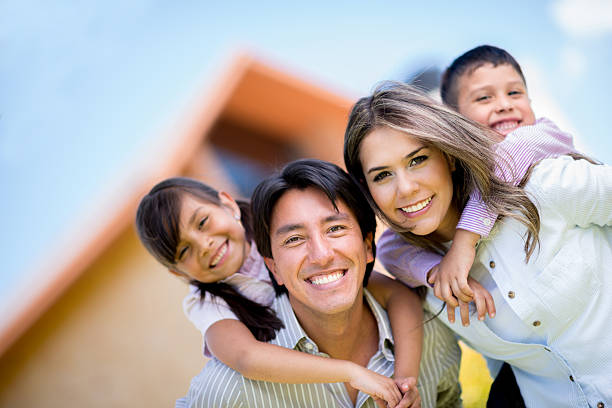 istock Family outside their house 477123713