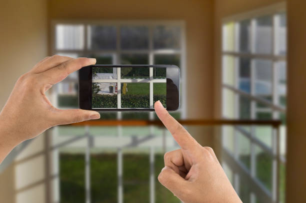 istock Hands taking photo house window detail 477124410