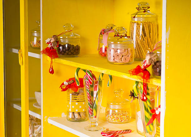 istock Candies on Glass Jars at Yellow Shelves 477124838