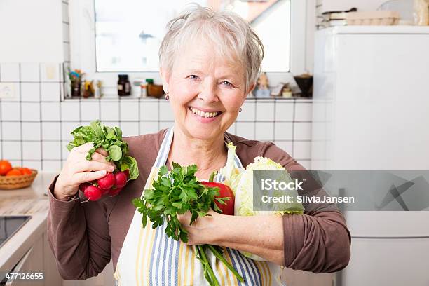 Senior Woman In Kitchen With Vegetables Stock Photo - Download Image Now - 50-59 Years, 55-59 Years, 60-69 Years