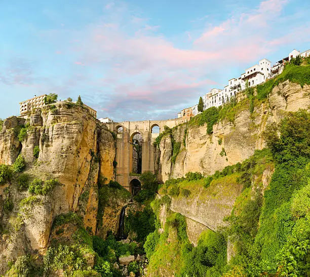 New bridge (Puente Nuevo) and the famous white houses on the cliffs in the city Ronda, Andalusia, Spain. 