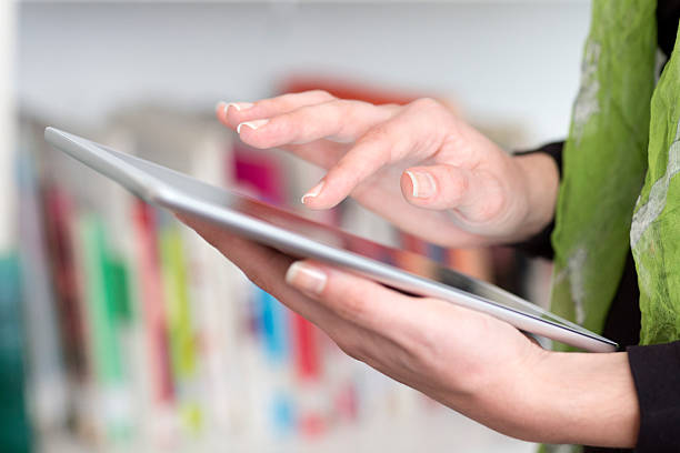 istock Young woman hand holding a Tablet PC 477128433