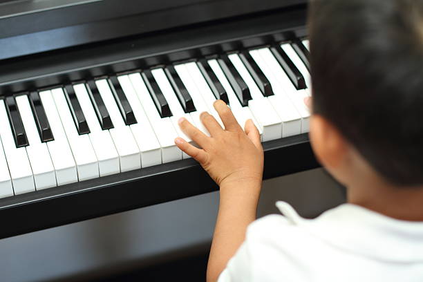 istock Japanese boy playing a piano 477129386