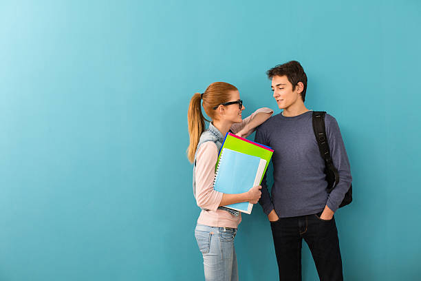 istock Two teenage students holding books 477129635