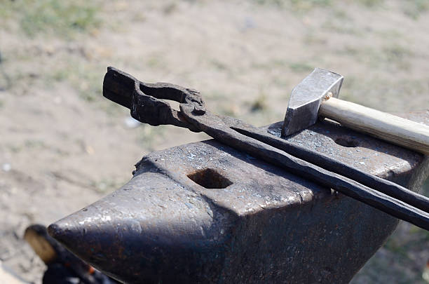 istock Blacksmith tools - anvil,sledgehammer and forge tongs, still life 477130402