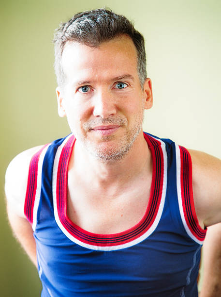istock Smiling handsome mature man in tank top blue eyes 477131664