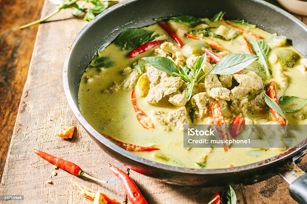 Green pork Curry , Thai cuisine Green pork Curry on wooden table with rice Curry - Meal Stock Photo