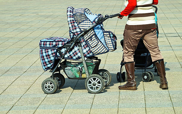 istock woman with baby carriage 477133115