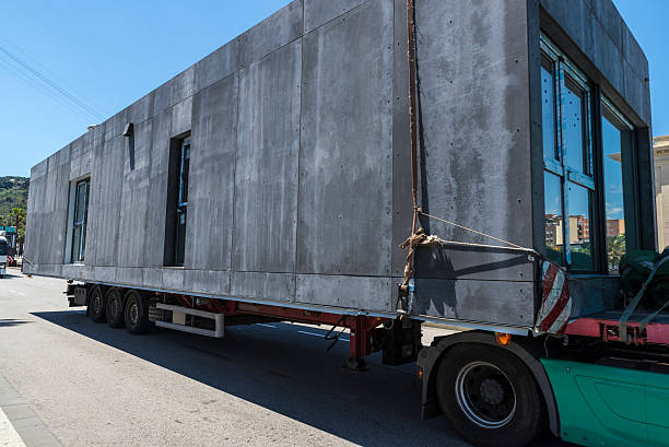Modular home Truck carrying a module prefabricated concrete housing in Barcelona, Catalonia, Spain prefabricated building stock pictures, royalty-free photos & images