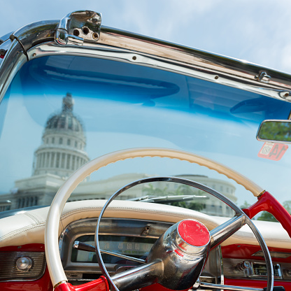 View from behind the steering wheel of a vintage car on the Capitolo in Old Havana, Cuba