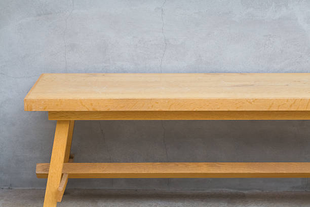 istock Brown wood bench and concrete wall background 477135214