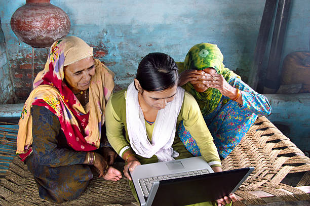 istock Mother and Daughter Holding Laptop at Home 477135554