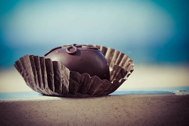 Chocolate truffle on the beach stock photo