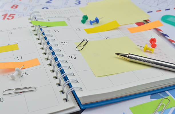 istock Pen with colourful notes and pin on business diary page 477141614