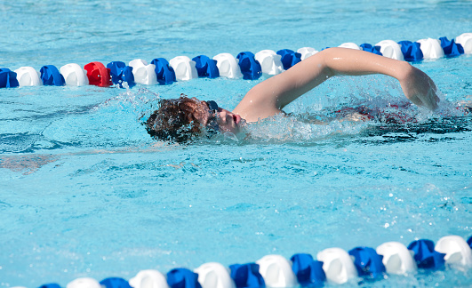 Young boy swimming the freestyle swim stroke