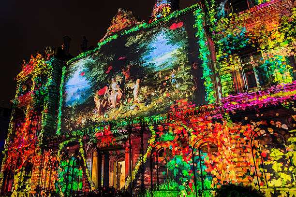 Lyon, France - December 6, 2014: street view with artistic performance at Festival of Lights in Lyon, France. The origins of this festival, named Fete des Lumieres, date to 1643.