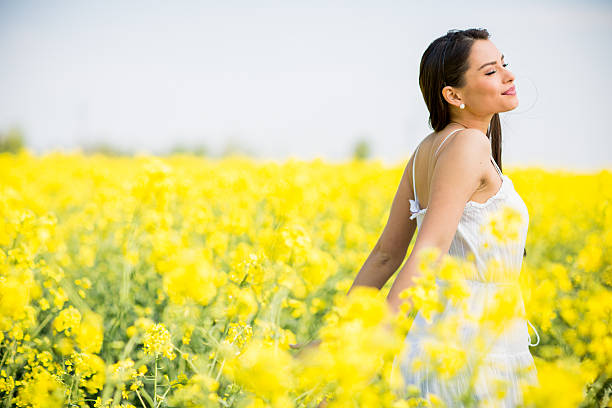 istock Young woman in the spring field 477151190