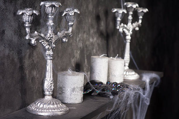 Tarantula Spider on Eerie Cobweb Covered Mantle with Candles and Candelabras in Haunted House Setting
