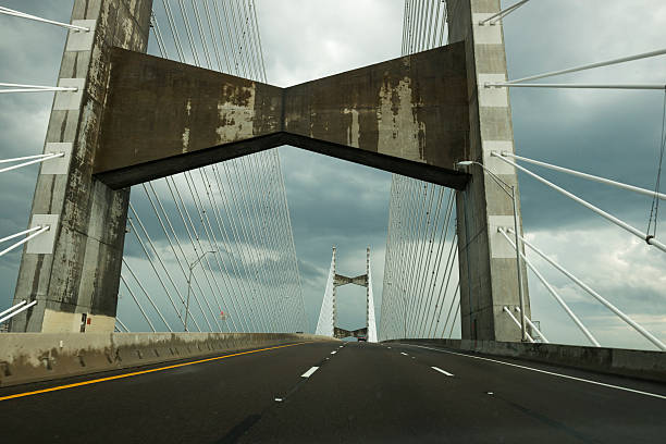 Stormy skies rise above the Dames Point Bridge on I-295 in Jacksonville, Florida. The Dames Point Bridge is a cable-stayed bridge, completed in 1989, and crosses the St. John's River.