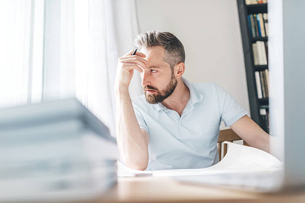 istock young man sitting on desk and working 477154664