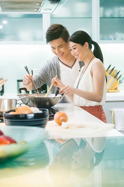 istock Young Chinese Couple in Kitchen 477154836