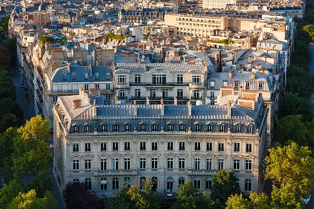 Photo of Haussmanian building with curvilinear facade and Paris Rooftops, France