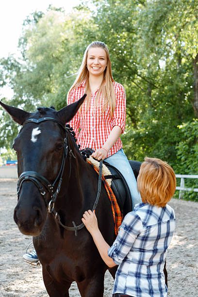 istock Smiling girl sitting in the saddle 477160176