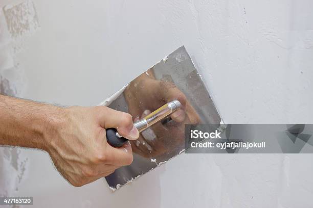 Man Hand With Trowel Plastering A Wall Stock Photo - Download Image Now - 2015, Activity, Adult