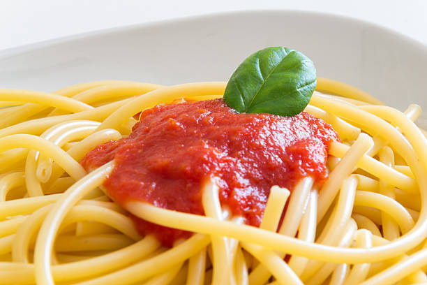 istock Italian spaghetti dish with tomatoes and basil 477163202