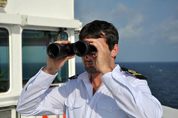 navigator with binoculars stock photo