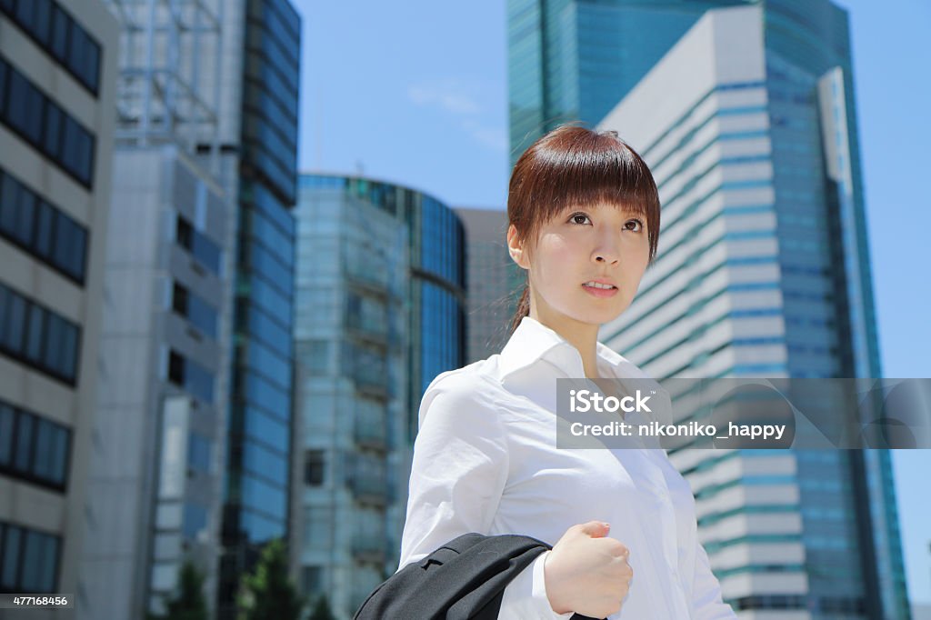 Woman toward the office She takes off the jacket of the suit on a summer hot day and walks. 2015 Stock Photo